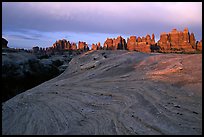 Sandstone swirls and Needles near Elephant Hill, sunset. Canyonlands National Park, Utah, USA. (color)