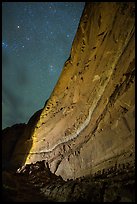 Illuminated canyon wall with rock art under starry sky, Horseshoe Canyon. Canyonlands National Park, Utah, USA. (color)