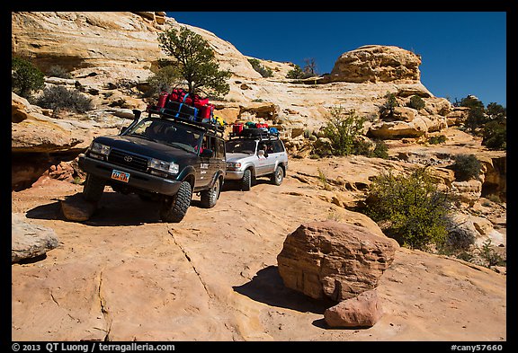 Vehicles on ledge in Teapot Canyon. Canyonlands National Park, Utah, USA.