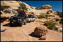 Vehicles on ledge in Teapot Canyon. Canyonlands National Park, Utah, USA. (color)