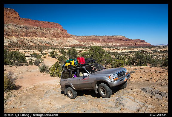 4WD vehicle driving over rocks in Teapot Canyon. Canyonlands National Park, Utah, USA.