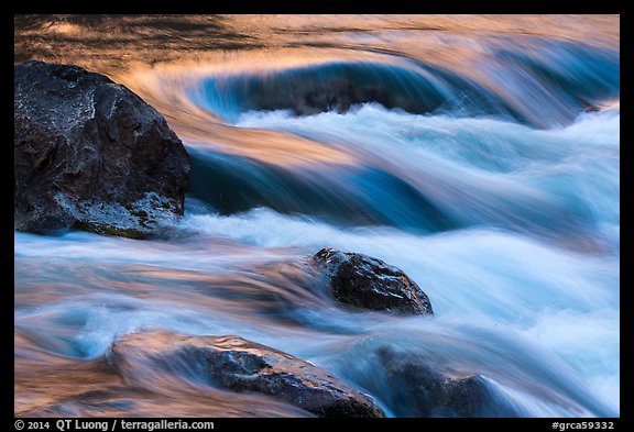 Boulders and rapids with color from canyon walls reflected. Grand Canyon National Park (color)