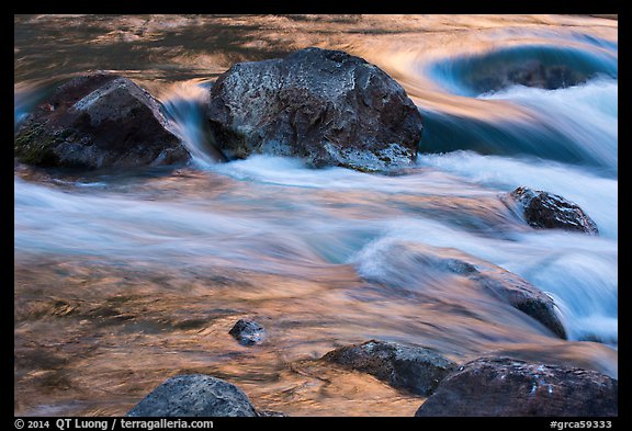 Boulders and rapids with glow from canyon walls reflected. Grand Canyon National Park (color)