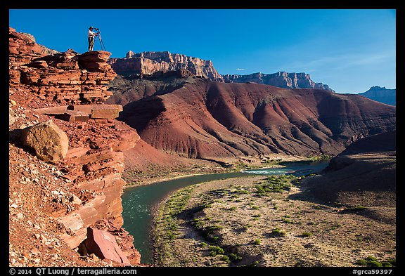 Photographer on steep cliff above Unkar rapids. Grand Canyon National Park (color)