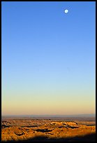 Sky, moon and badlands, sunrise. Badlands National Park, South Dakota, USA.
