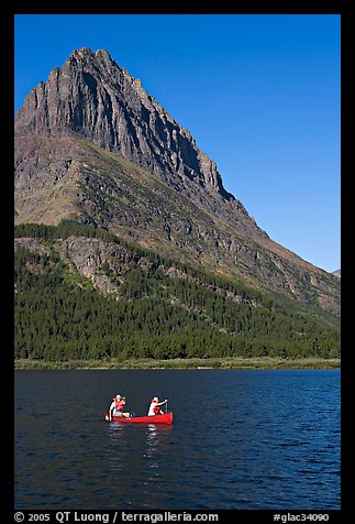 Red canoe on Swiftcurrent Lake. Glacier National Park, Montana, USA.