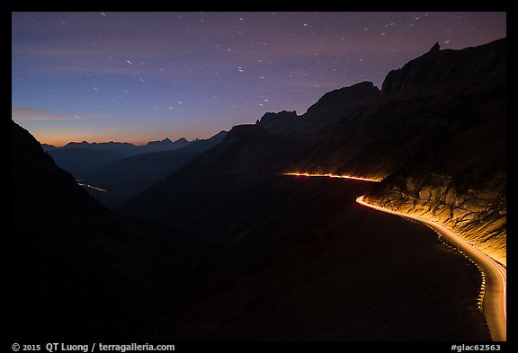 Going-to-the-Sun road at dusk with car lights. Glacier National Park, Montana, USA.