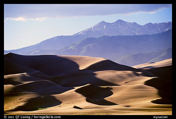 Distant view of dunes and Sangre de Christo mountains in late afternoon. Great Sand Dunes National Park, Colorado, USA.