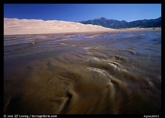 Medano creek with shifting sands, dunes and Sangre de Christo mountains. Great Sand Dunes National Park, Colorado, USA.