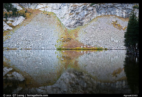 Rock talus reflected in Lower Sand Creek Lake. Great Sand Dunes National Park and Preserve, Colorado, USA.