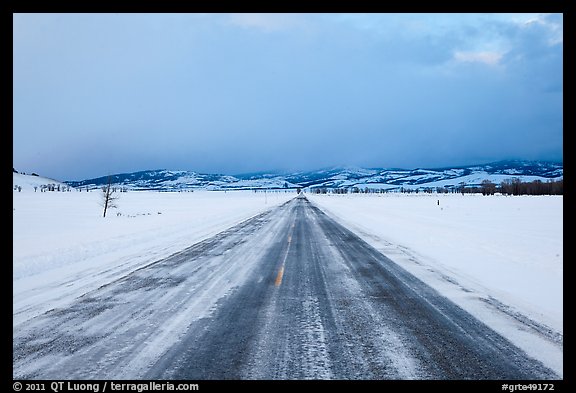 Road in winter at dusk, Gross Ventre valley. Grand Teton National Park, Wyoming, USA.