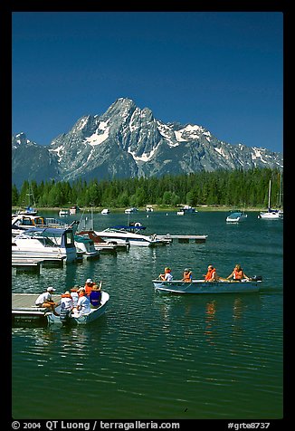 Boaters at Colter Bay marina with Mt Moran in the background, morning. Grand Teton National Park, Wyoming, USA.