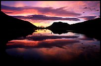Colorful sunrise clouds reflected in a pond in Horseshoe park. Rocky Mountain National Park, Colorado, USA. (color)