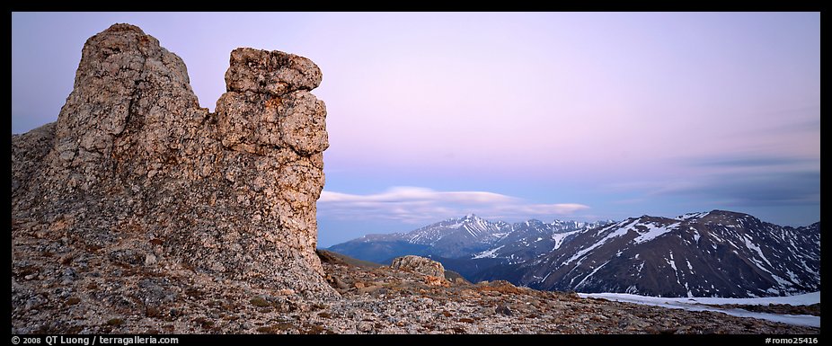 Rock towers on high pass and mountains at dusk. Rocky Mountain National Park, Colorado, USA.
