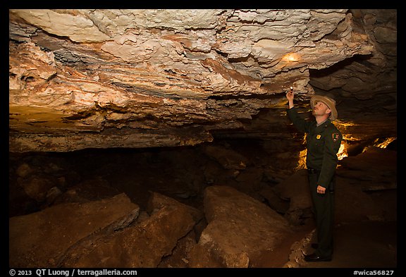 Ranger pointing at speleotherm in large cave room. Wind Cave National Park (color)