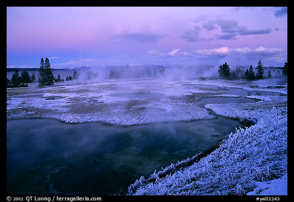 West Thumb Geyser Basin covered by snow at dusk. Yellowstone National Park, Wyoming, USA.