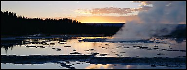 Steam rising in geyser pool at sunset. Yellowstone National Park (Panoramic color)