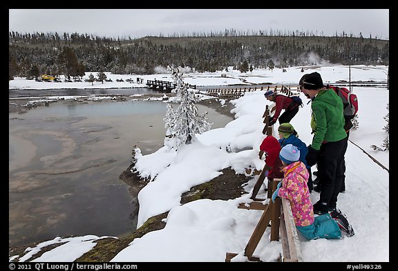 Family looks at thermal pool in winter. Yellowstone National Park (color)