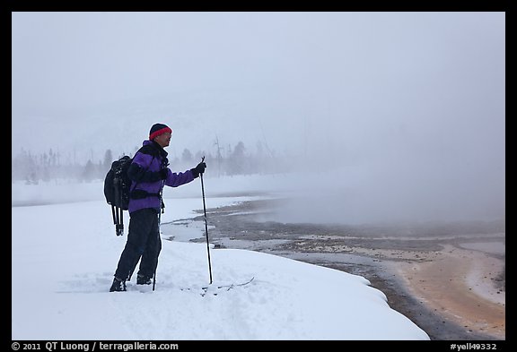Skier at the edge of thermal pool. Yellowstone National Park, Wyoming, USA.