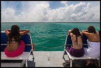 Women sunning themselves on snorkeling boat. Biscayne National Park, Florida, USA. (color)
