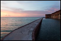 Fort Jefferson moat and walls at sunset with tourists in distance. Dry Tortugas National Park, Florida, USA. (color)