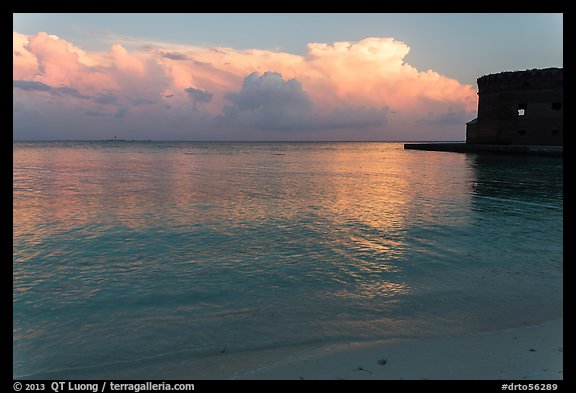 Tropical clouds, beach, and fort at sunrise. Dry Tortugas National Park, Florida, USA.