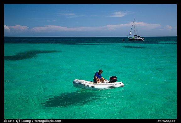 Dinghy and sailbaot in transparent waters, Loggerhead Key. Dry Tortugas National Park, Florida, USA.