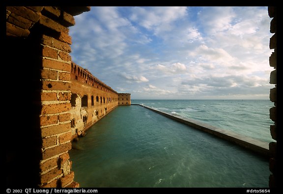 Fort Jefferson wall and moat, framed by cannon window. Dry Tortugas National Park, Florida, USA.