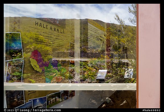 Haleakala slopes and native garden with signs, Park Headquarters Visitor Center window reflexion. Haleakala National Park (color)