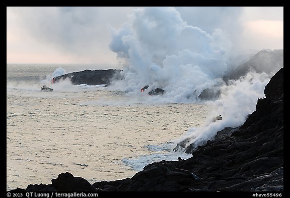 Steam rising off lava flowing into ocean. Hawaii Volcanoes National Park, Hawaii, USA.