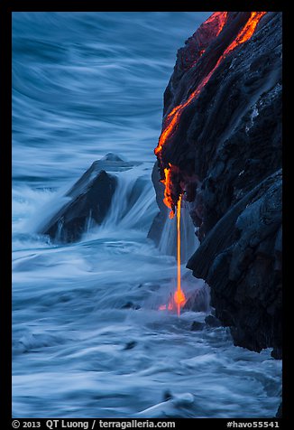 Hot lava drips into ocean waters at dawn. Hawaii Volcanoes National Park, Hawaii, USA.
