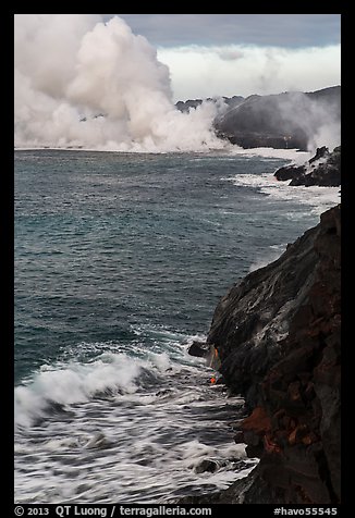 Coast with lava and clouds of smoke and steam produced by lava contact with ocean. Hawaii Volcanoes National Park (color)