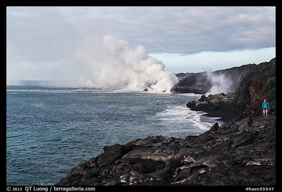 Hiker and volcanic steam cloud on coast. Hawaii Volcanoes National Park, Hawaii, USA.