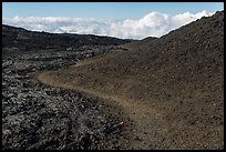 Trail through olivine hill bordering aa lava. Hawaii Volcanoes National Park, Hawaii, USA. (color)