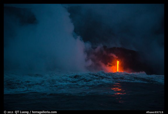 Lava runs down the cliff and goes into the sea at dawn. Hawaii Volcanoes National Park, Hawaii, USA.