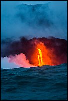 A single spigot of lava creates a large plume steam at sunrise upon reaching ocean. Hawaii Volcanoes National Park, Hawaii, USA. (color)