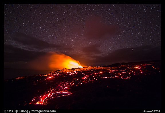 Molten lava flow and plume from ocean entry with stary sky at night. Hawaii Volcanoes National Park, Hawaii, USA.