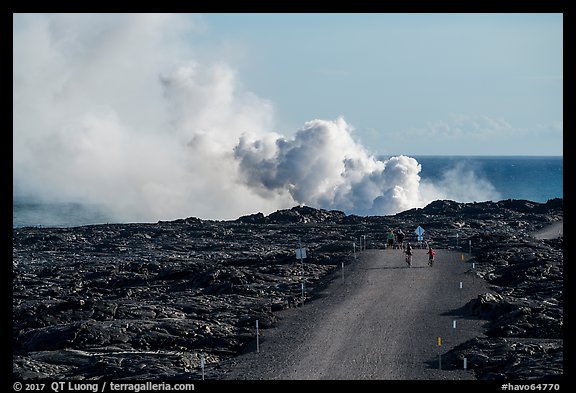Byciclists and hikers approaching lava ocean entry on emergency road. Hawaii Volcanoes National Park, Hawaii, USA.