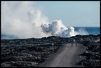 Byciclists and hikers approaching lava ocean entry on emergency road. Hawaii Volcanoes National Park, Hawaii, USA.