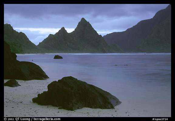 Balsalt boulders on South Beach, Sunuitao Peak in the background, Ofu Island. National Park of American Samoa