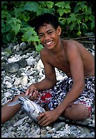 Samoan boy with fish, Tau Island. National Park of American Samoa