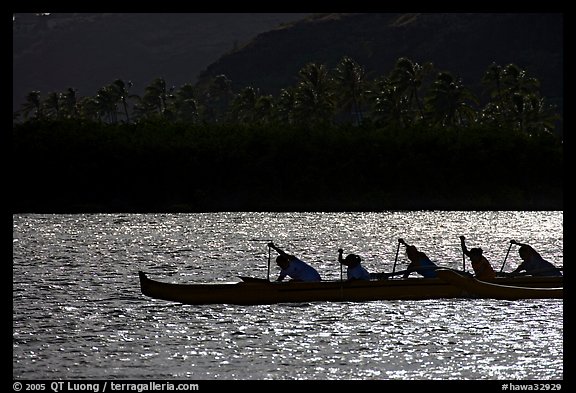 Backlit outrigger canoe, Maunalua Bay, late afternoon. Oahu island, Hawaii, USA