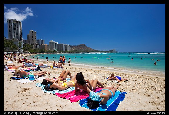Young women sunning on Waikiki Beach. Waikiki, Honolulu, Oahu island, Hawaii, USA (color)