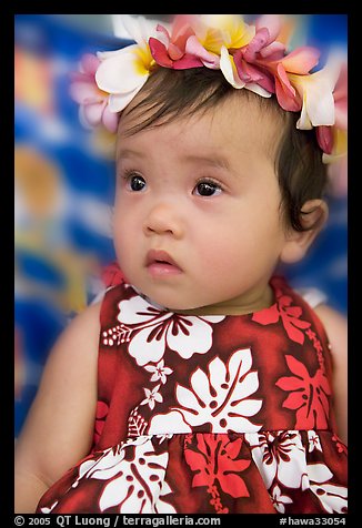 Baby girl in hawaiian dress wearing a flower lei on her head. Waikiki, Honolulu, Oahu island, Hawaii, USA (color)