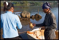 Fisherman giving a freshly caught crab to his wife, Kaneohe Bay, morning. Oahu island, Hawaii, USA (color)