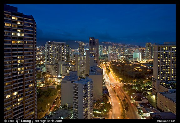 Boulevard and high-rise towers at dusk. Waikiki, Honolulu, Oahu island, Hawaii, USA