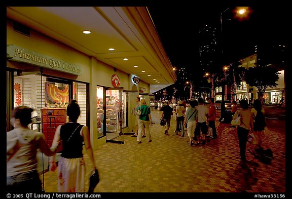 Shops on Kalakaua avenue at night. Waikiki, Honolulu, Oahu island, Hawaii, USA