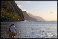 Couple standing in water, Kee Beach, late afternoon. Kauai island, Hawaii, USA (color)