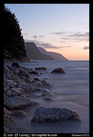 Boulders, surf, and Na Pali Coast, sunset. Kauai island, Hawaii, USA (color)