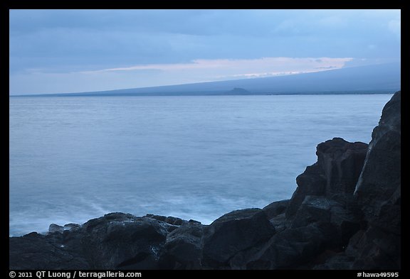 Lava rock shore and Mauna Loa shield profile from South Point. Big Island, Hawaii, USA